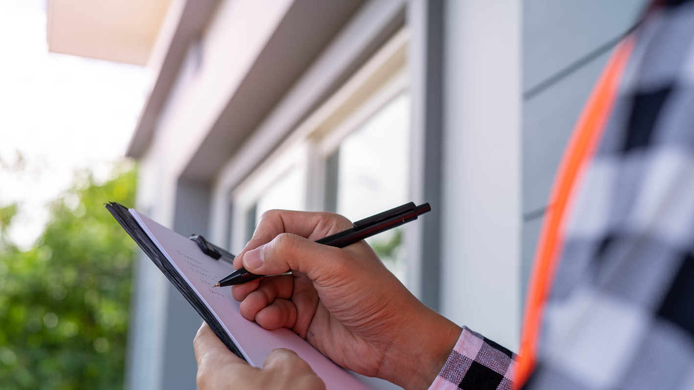 A person writing on a piece of paper with a pen